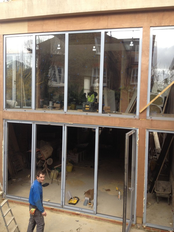 Aluminium bi-fold doors with two-storey glazing in North Finchley
