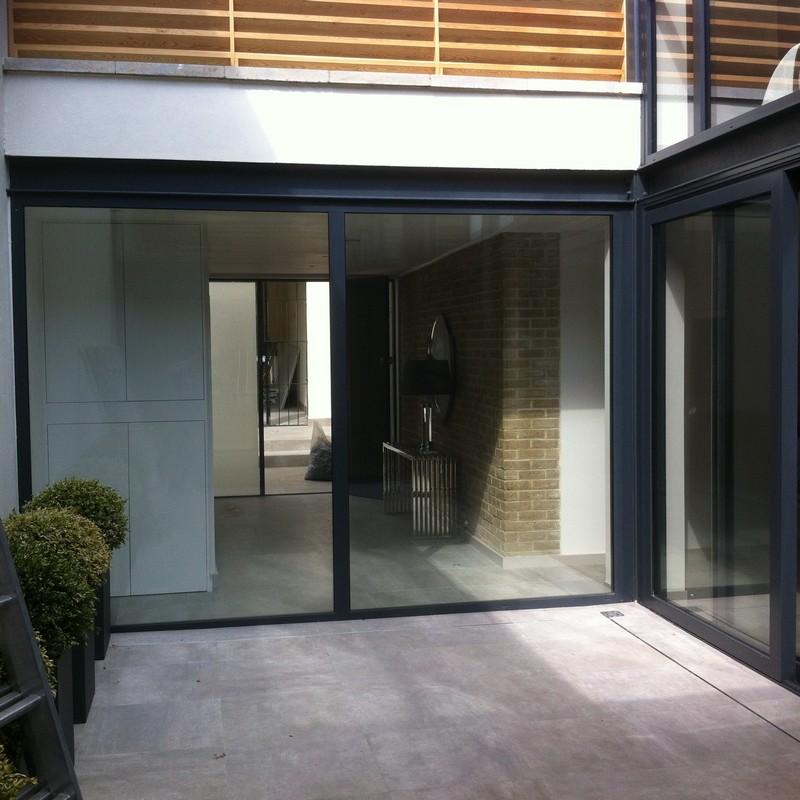 Floor-to-ceiling sliding doors opening to courtyard in North Finchley