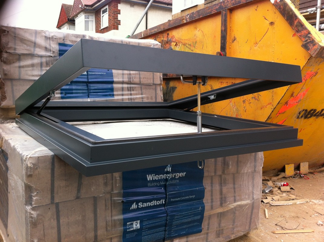 Opening flat roof skylight in anthracite grey installed in North Finchley