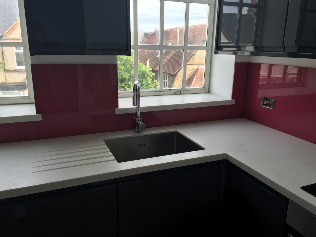Deep plum coloured glass splashback in modern North Finchley kitchen